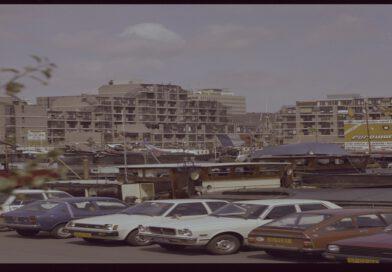 De Leuvehaven met binnenvaartschepen en geparkeerde auto’s, 1983